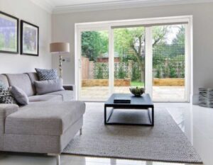 Patio doors in a living room, leading out to a back yard 