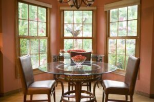 A kitchen table surrounded by stunning bay windows